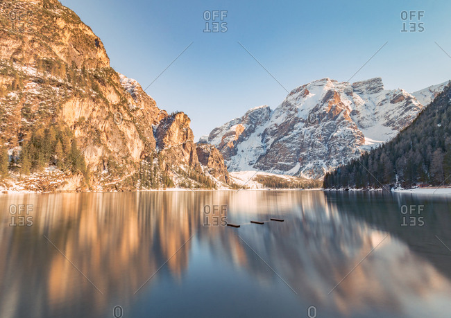 Breathtaking landscape with magical reflection of rocky mountains in crystal lake water in bright sunny day