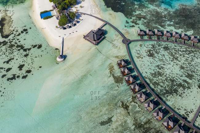 Maldives- South Male Atoll- aerial view of resort with bungalows on island Olhuveli