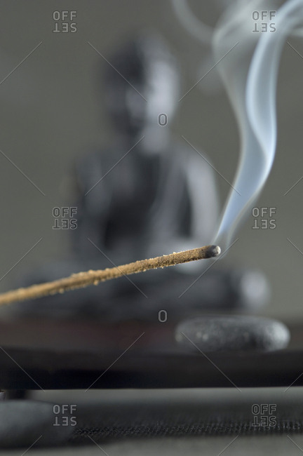 Joss stick and Buddha figurine