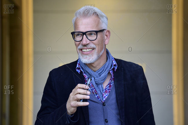 Portrait of a mature man- smoking electronic cigarette