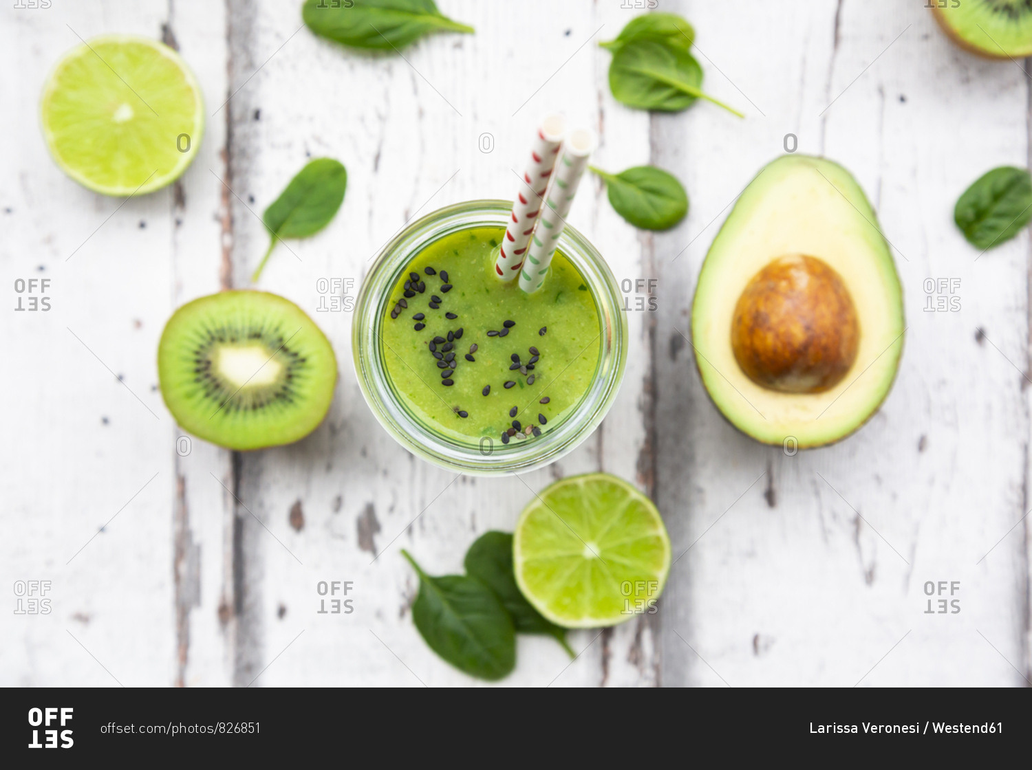 Glass of green smoothie with avocado- spinach- kiwi and lime