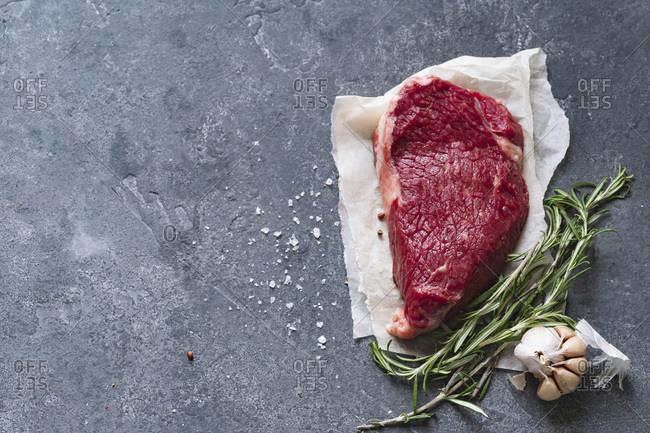 Raw black angus prime beef steak variety with rosemary, sea salt and spices