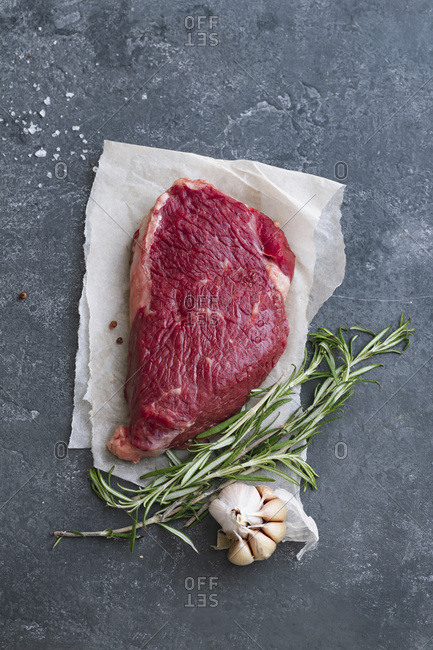 Raw black angus prime beef steak variety with rosemary, sea salt and spices