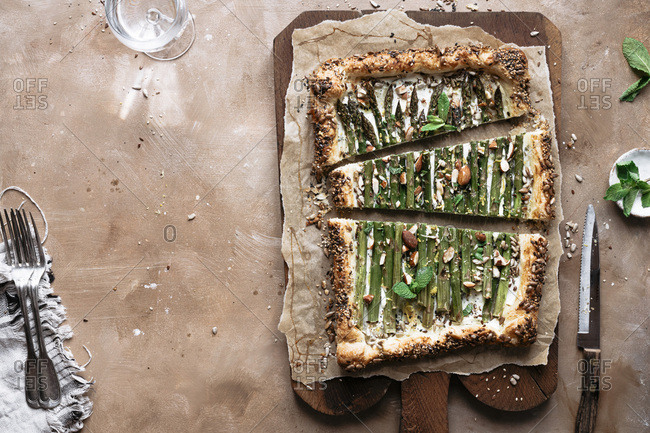 Asparagus tart on a brown board / with negative space