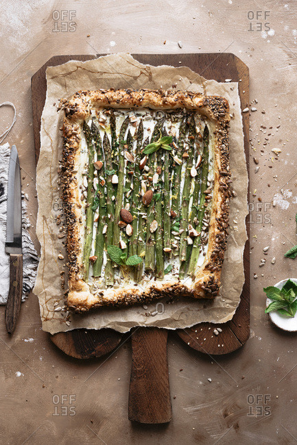 Asparagus tart onto parchment paper on a cutting board