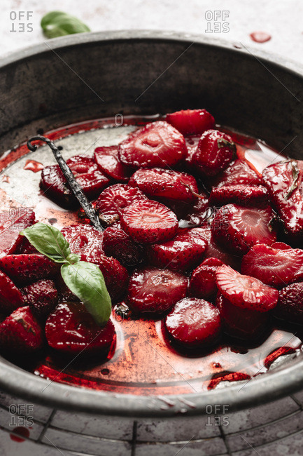 Roasted juicy strawberries on a metal plate