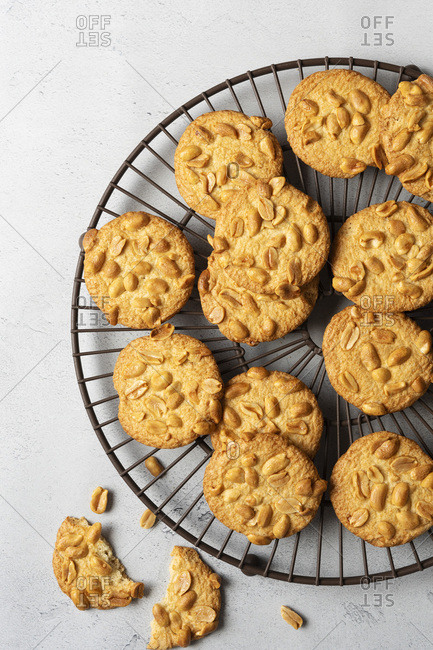 Homemade peanut biscuits cooling on a wire rack.