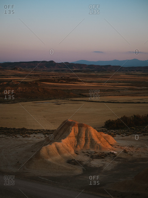 Desert geological formation illuminated by sunset golden light