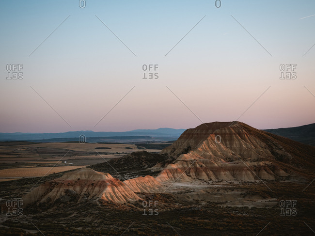 Desert geological formation illuminated by sunset golden light