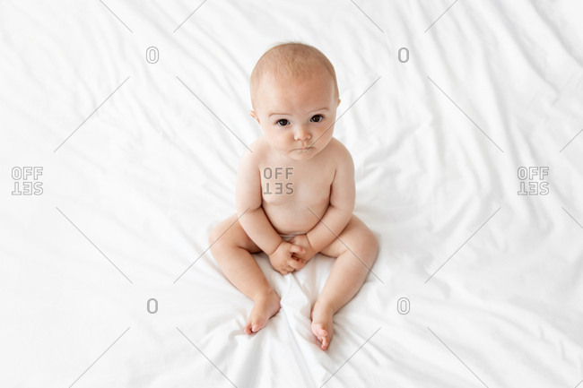 Nude toddler on bed