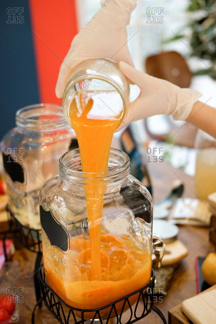 Woman preparing orange drink