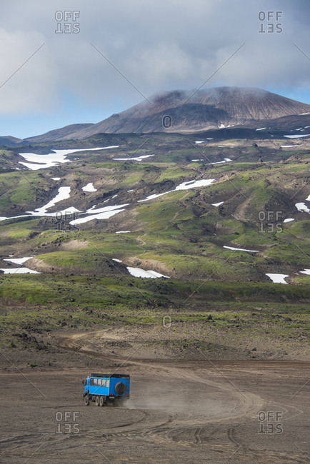 Russia- Kamchatka- Gorely volcano- truck driving through the lava sand