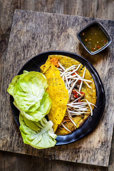 Banh xeo with lettuce and Nuoc Cham dipping sauce