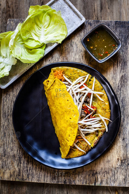 Banh xeo with lettuce and Nuoc Cham dipping sauce