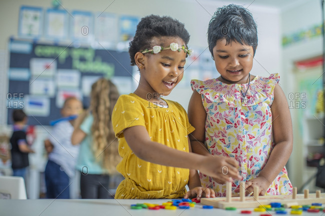 Two girls playing a game in kindergarten