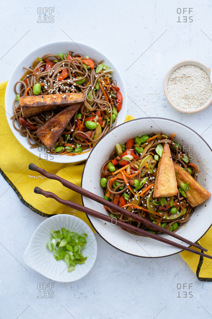Asian-styled lunch with vegetarian soba noodles with fried vegetables, edamame beans and tofu