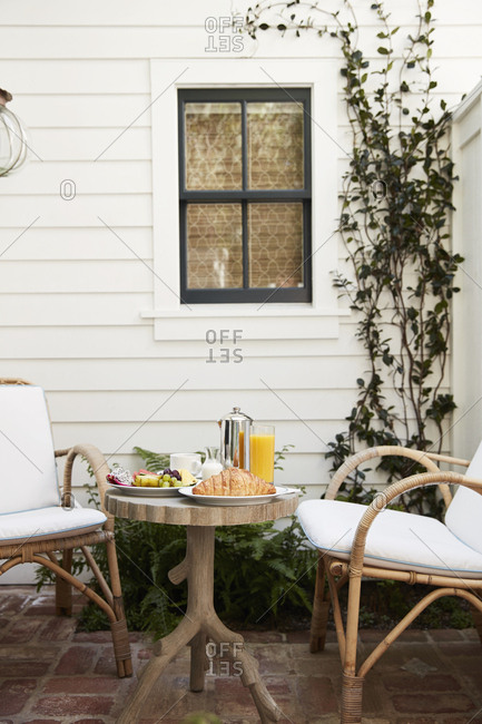 Patio with wicker chairs and wooden table