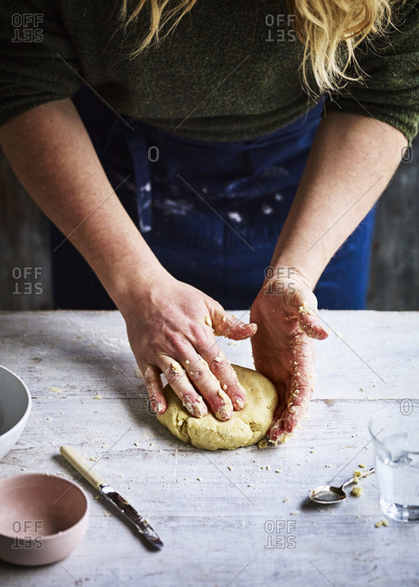 Baker making pastry dough by hand