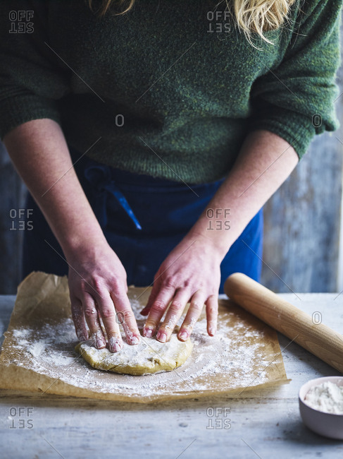 Pastry being made by hand and rolled out with a rolling pin