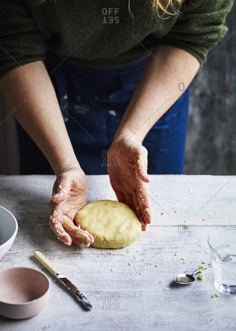 Baker shaping pastry dough by hand