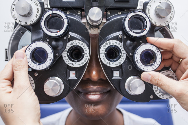 Studying a woman's eyesight with a phoropter, close up