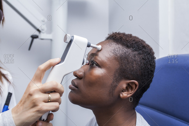 Eye examination with an ophthalmologist, side view