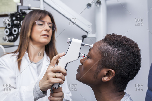 Eye examination with an ophthalmologist, side view