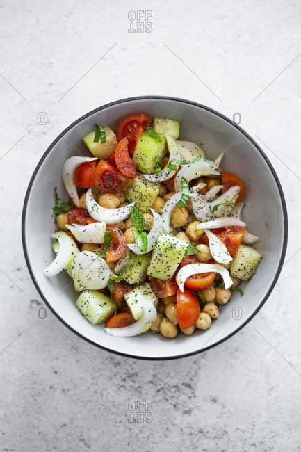 Salad with cucumbers- chickpeas- onion- cherry tomatoes- basil- chia seed