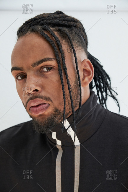African American Man With Braids Looking At Camera Stock Photo