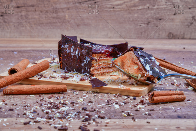 Served delicious chocolate dessert with cinnamon on wooden board with spoon