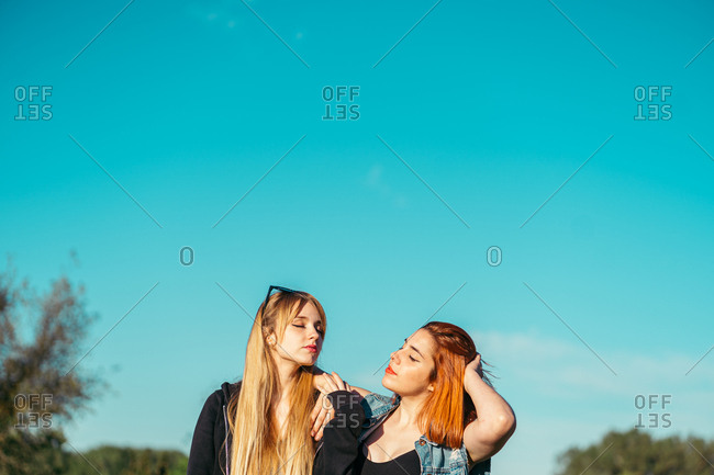 Lesbians standing on terrace in countryside