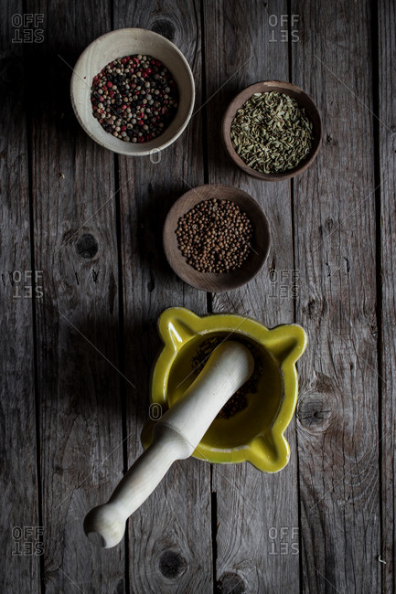 Top view of mixed dry spices and mixing mortar on wooden table board