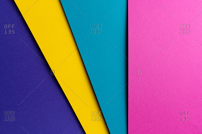 Layout of colorful cardboard sheets in blue, purple, pink and yellow shades
