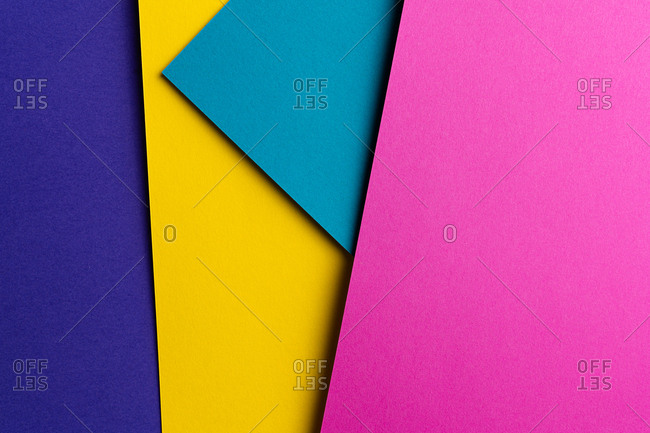 Layout of colorful cardboard sheets in blue, purple, pink and yellow shades