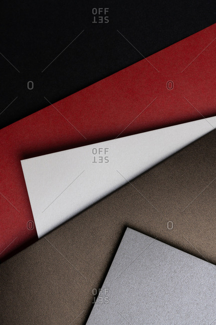 From above layout of pastel glitter cardboard sheets in brown, white, red and grey shiny shades