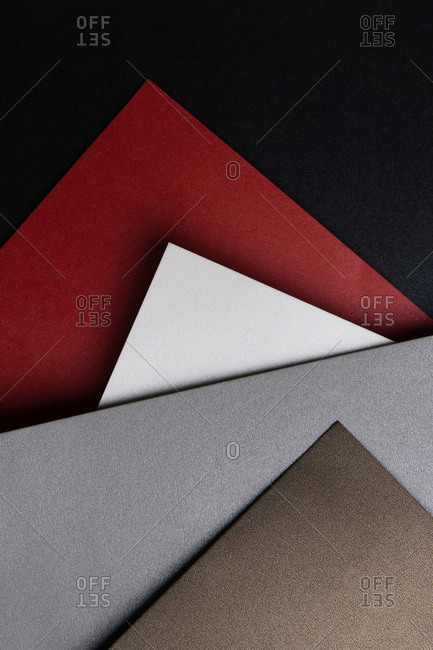 From above layout of pastel glitter cardboard sheets in brown, white, red and grey shiny shades
