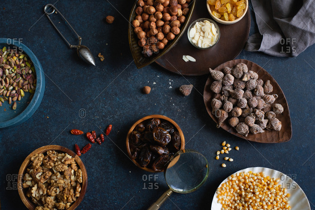 Top view of various nuts and dried fruits: hazelnuts, walnuts, raisins