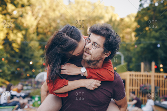 Candid moment, young couple in love having fun at outdoors festival during summer.