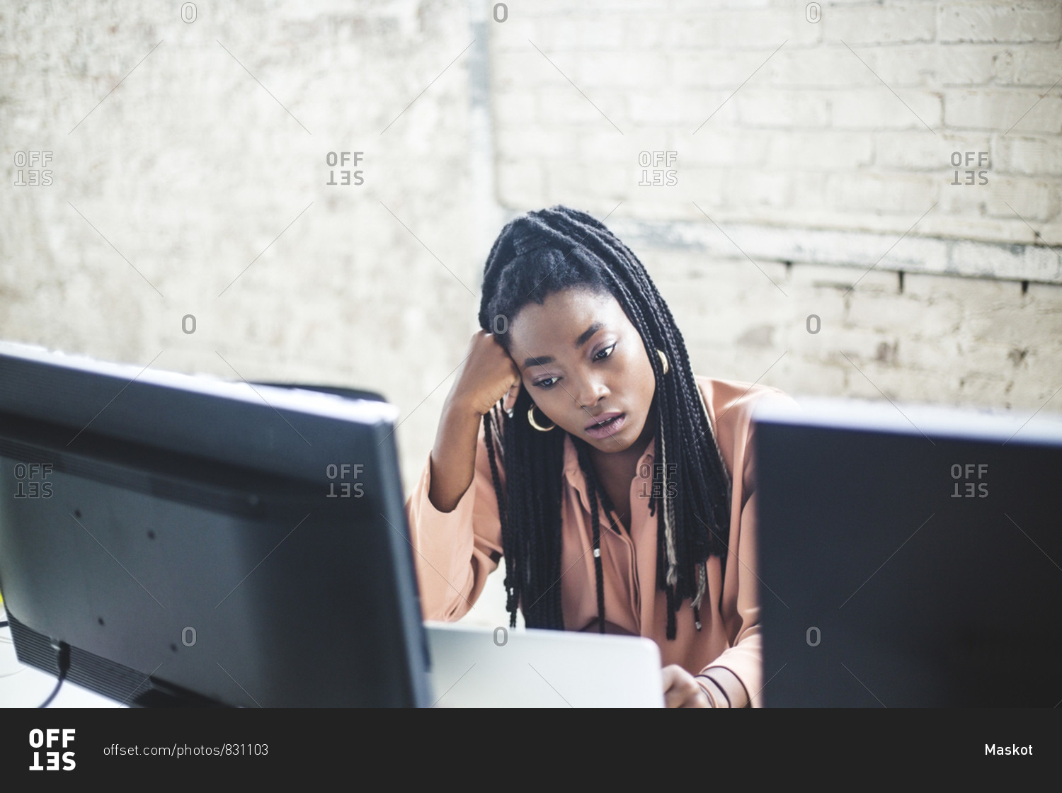 High angle view of young female computer hacker coding at desk in office