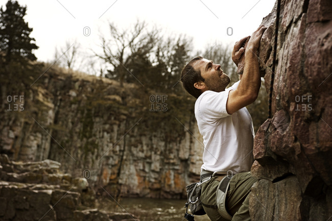 A man sport climbs at Palisades State Park, South Dakota.