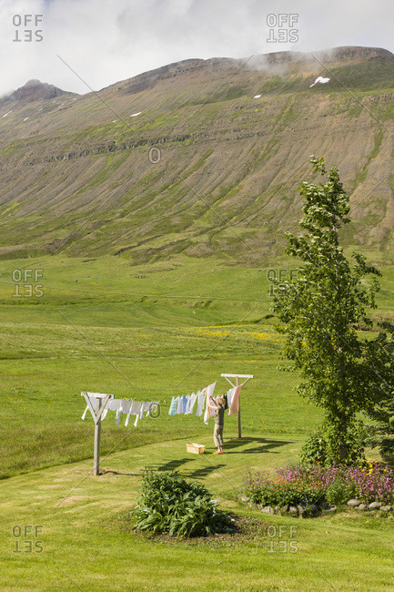 Woman hanging out clothes to dry.