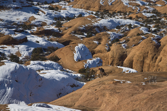 Mountain biker riding on slickrock in Moab, Utah.
