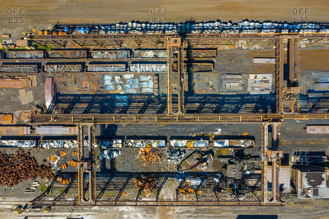Aerial view of rail road cars, scrap metals and finished steel products at a modern steel producing facility on the shores of Lake Michigan in Indiana.