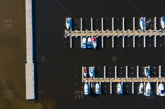 Aerial view of yachts and sailboats in late afternoon sunlight during early spring at a yacht harbour in Michigan City, IN in the United States