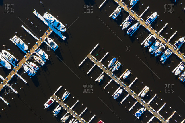 Aerial view of yachts and sailboats in late afternoon sunlight during early spring at a yacht harbour in Michigan City, IN in the United States