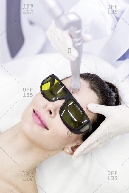 Beauty technician using laser treatment. This treatment is used to treat scars, wrinkles and stretch marks, but also for pigmentation removal.