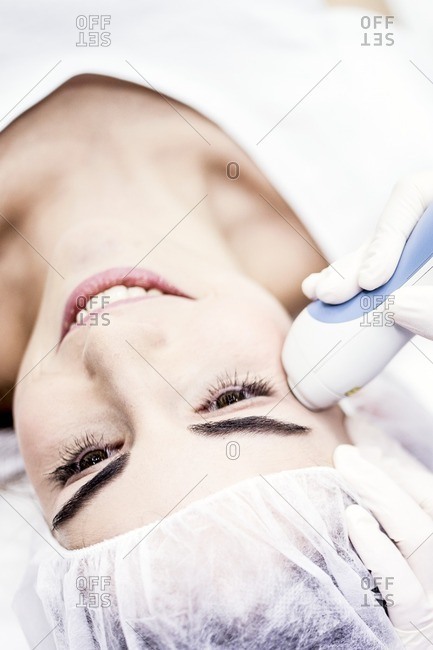 Young woman having laser peeling treatment, close-up. This treatment smooths and rejuvenates the skin.