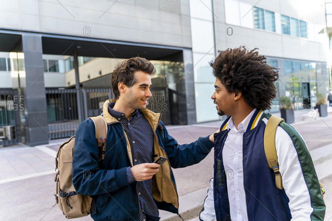 Two casual businessmen meeting in the city- Barcelona- Spain