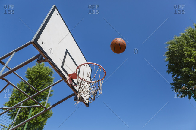 Basketball and hoop- blue sky