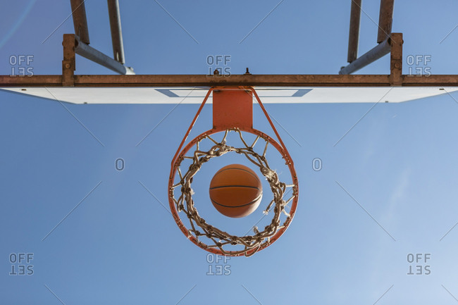 Basketball and hoop- blue sky- upward view